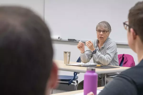 A professor engages with class.